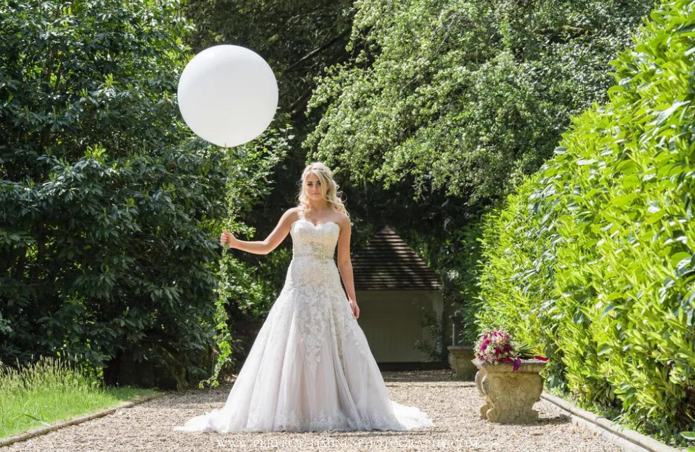 Bride in garden with balloon